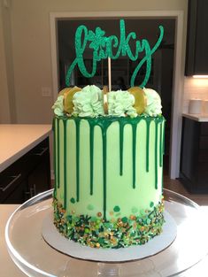 a birthday cake with green icing and sprinkles