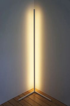 the light is shining on the floor in front of two tall poles with sticks sticking out of them