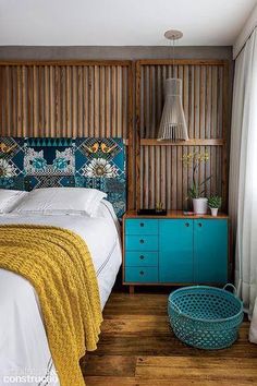 a bedroom with wood paneling and blue accents