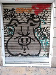 an open garage door with graffiti on it