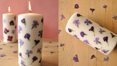 two white candles with purple flowers on them and one has a lighter in the middle