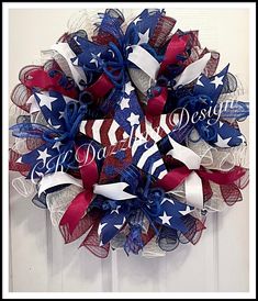 a patriotic wreath with red, white and blue ribbons