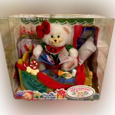 a white teddy bear sitting in a chair with christmas decorations on it's chest