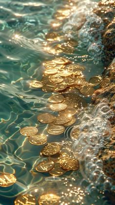 some gold coins are floating in the water