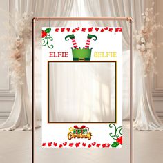 a christmas photo frame with an elf's hat on it