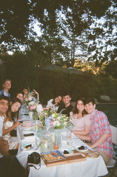 a group of people sitting around a table