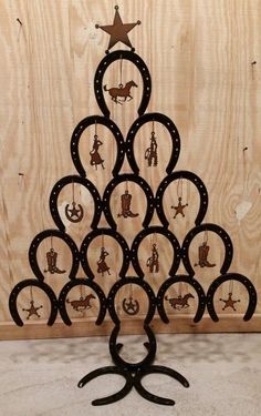 a metal christmas tree made out of horseshoes