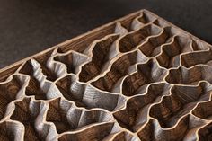 an intricate wood carving is shown on the table top, and it looks to be made out of wood