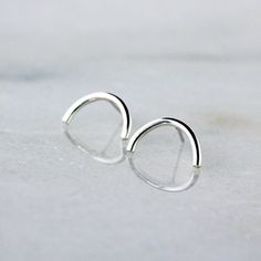 Open half-circles in bright sterling silver hang perfectly from silver posts soldered in place at the top of the circle. These are simple yet sophisticated earrings that will move easily with you from day into evening. They're so easy to wear that you could forget you have them on. The half-circles measure 14mm across at their widest point, and the earrings include sterling silver wingnut backs. ONE WEEK PROCESSING TIME: All my work is made-to-order, specifically for you. My turn-around time (i. Crescent Moon Earrings, Circle Studs, Half Circle, Moon Earrings, Style Minimalist, Earrings Sterling Silver, Minimalist Jewelry, Crescent Moon, Everyday Style