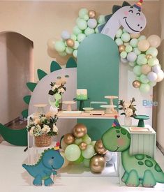 a dinosaur themed birthday party with balloons and decorations