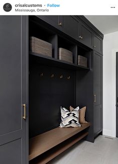 a black and white entryway with lots of storage space on the wall, along with some decorative pillows