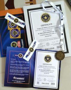 two certificates, one with a medal and the other with an award on it