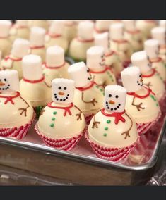 some cupcakes with frosting on them are in the shape of snowmen