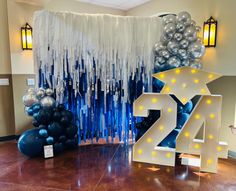 balloons and streamers decorate the entrance to a new year's eve party