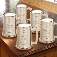 six personalized beer mugs sitting on top of a kitchen counter