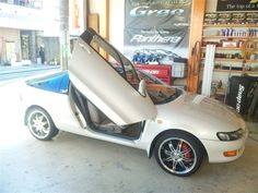 a white sports car with its doors open