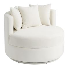 a white round couch with pillows on it