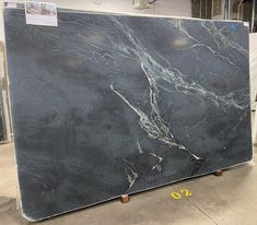 a large black marble slab in a warehouse