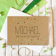 a card that says, michael will you be my page boy? on it next to some crafting supplies