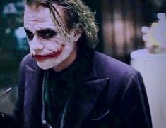 the joker is dressed in black and has his hair styled like a clown's face