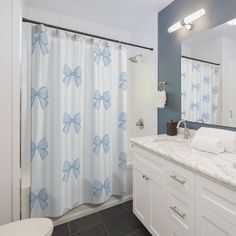 a bathroom with blue and white shower curtains