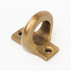 a brass plated metal object on a white background