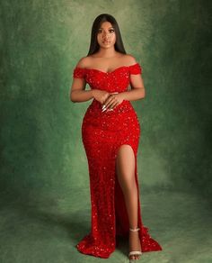 a woman in a red dress posing for the camera