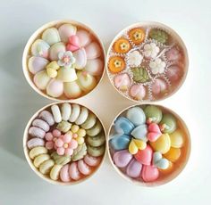 four bowls filled with different types of candies