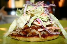 a pizza topped with lettuce, meat and coleslaw