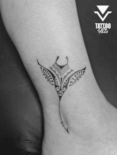 a black and white photo of a tattoo on the foot