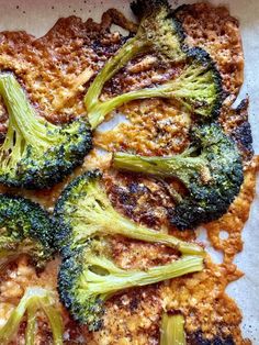 broccoli florets on top of some kind of meat