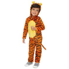 a little boy dressed in a tiger costume holding a yellow piece of paper and posing for the camera