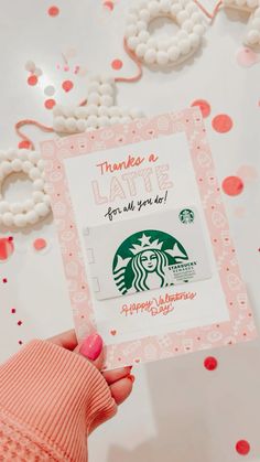 someone holding up a starbucks card for valentine's day