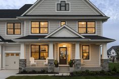 a large white house with lots of windows on it's sides and front porch