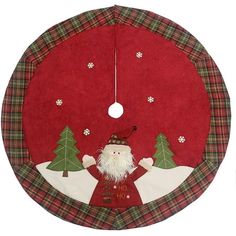 a christmas decoration hanging from the side of a red circular object with a santa clause on it