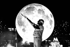 a man standing on top of a stage with his arms in the air while holding a baseball bat