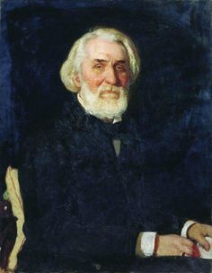 an old man with white hair and beard sitting in a chair wearing a black coat