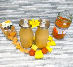 two jars filled with food sitting on top of a table