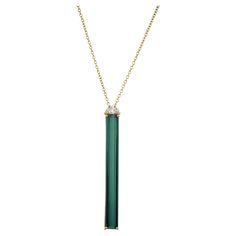 This unique and rare Tourmaline and diamond pendant necklace comes from the Peter Suchy Workshop. 6.50 carat elongated emerald cut deep green tourmaline is set in four prong 18k yellow gold setting. A half moon accent diamond sits atop of the tourmaline with an 18 inch yellow gold link chain attached. 1 elongated rectangular green tourmaline, approx. 6.50cts 1 half moon diamond, I VS approx. .19cts 18k yellow gold Stamped: 750 4.7 grams Top to bottom: 43.2mm or 1.70 Inches Width: 4.4mm or .17 In Half Moon Diamond, Gold Link Chain, Tourmaline Pendant, Gold Link, Yellow Gold Setting, Yellow Gold Pendants, Diamond Pendant Necklace, Green Tourmaline, Gold Pendant Necklace