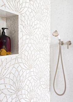 a bathroom with a shower head, soap and lotion