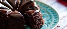 a chocolate cake on a blue plate sitting on a table