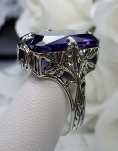 Simulated Purple Amethyst Ring GL Design#15 Custom Made Inspired by Art Deco era designs, I now offer this gorgeous reproduction in antiqued sterling silver. This lovely ring is set with high quality purple amethyst CZ rectangle-cut gemstone... The inside of the band is hallmarked 925 for sterling. This rectangle-cut purple CZ stone is 16mm (5/8th of an inch) by 12mm (1/2 inch) in size. The gem has perfect color and clarity. Notice the beautifully intricate design of the silver filigree setting Rectangular Amethyst Ring For Wedding, Rectangular Amethyst Wedding Jewelry, Rectangular Purple Amethyst Wedding Ring, Gothic Purple Ring As A Gift, Gothic Purple Ring For Gift, Gothic Purple Rings As Gift, Art Nouveau Purple Jewelry For Gift, Purple Art Nouveau Jewelry For Gift, Purple Art Nouveau Jewelry Gift