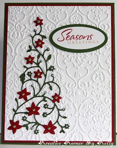 a white card with red flowers and green trimmings on the bottom, says season's greeting