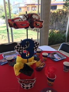 the table is set up for cars birthday party