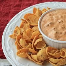 a white plate topped with chips and dip