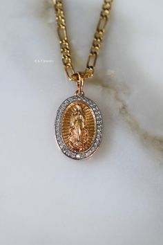 This a high quality oval Virgin Mary pendant with details on the front and back.  The shiny white stones have been mircopave set and look realistic.  The chain is a gold dipped figaro chain. We usually send 18 and 20 inch chains, but you can request another length in the note box at checkout. Original Price: $75 Gold Plated Oval Jewelry With Figaro Chain, Gold-plated Oval Gold Chain Jewelry, Gold Oval Pendant Chain Jewelry, Gold Plated Oval Gold Chain Jewelry, Oval Gold-plated Gold Chain Jewelry, Oval Pendant Necklace With Figaro Chain For Gift, Oval Pendant Necklaces With Figaro Chain For Gifts, Gold Necklaces With Figaro Chain And Oval Pendant, Figaro Chain Necklaces With Oval Pendant For Gift