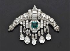 an art deco brooch with emeralds and diamonds