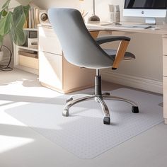 an office chair sits in front of a computer desk