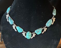 Sterling older Natural gorgeous large Turquoise Statement Necklace (I believe it is a unique studio made Mexican creation) that works with Southwestern , Mexican, contemporary jewelers and with gorgeous bright color.  Each baroque natural Turquoise is bezel set with stylized sterling links between the stones.  I've not seen another like it; what a  vision to see it worn.  Condition I see no problems, nice decorated box clasp, quality made-photos show the details.  Length approx. 20", center is approx. 1 1/4" wide, wt.- approx. 100 grams.  This is a Stunning artist hand wrought vintage Treasure. Collectible Turquoise Necklace With Natural Stones, Artisan Turquoise Necklace, Untreated Bohemian Turquoise Necklace For Collectors, Turquoise Statement Necklace, Large Necklace, Box Clasp, Make Photo, Wedding Jewellery Necklace, Metal Work