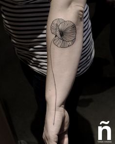 a woman's arm with a tattoo on it and a flower in the middle